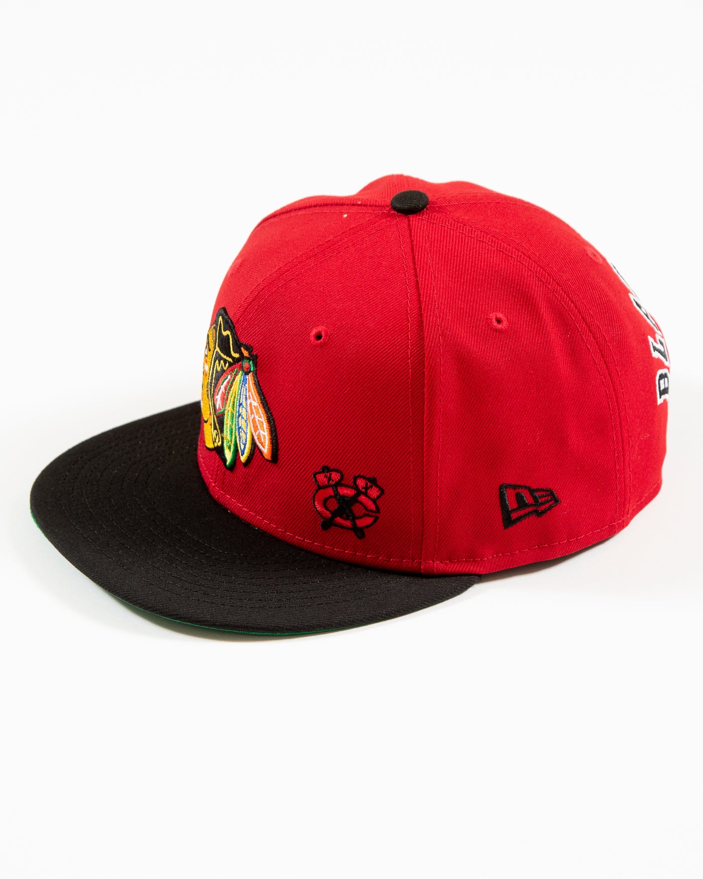 Red and black New Era snapback with Chicago Blackhawks primary logo and secondary logo embroidered on front - left side angle lay flat