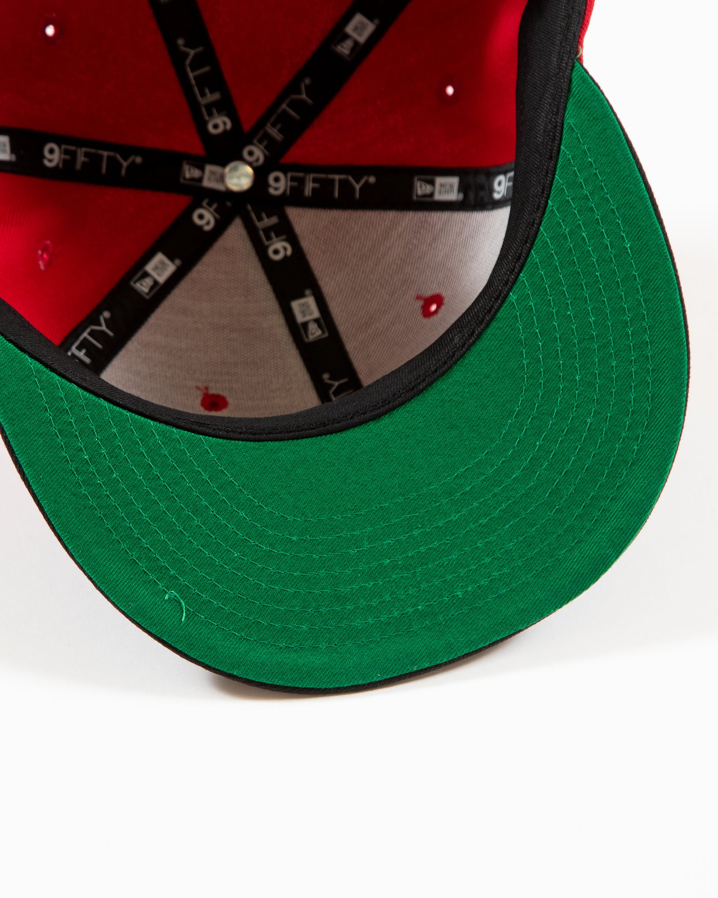 Red and black New Era snapback with Chicago Blackhawks primary logo and secondary logo embroidered on front - under brim