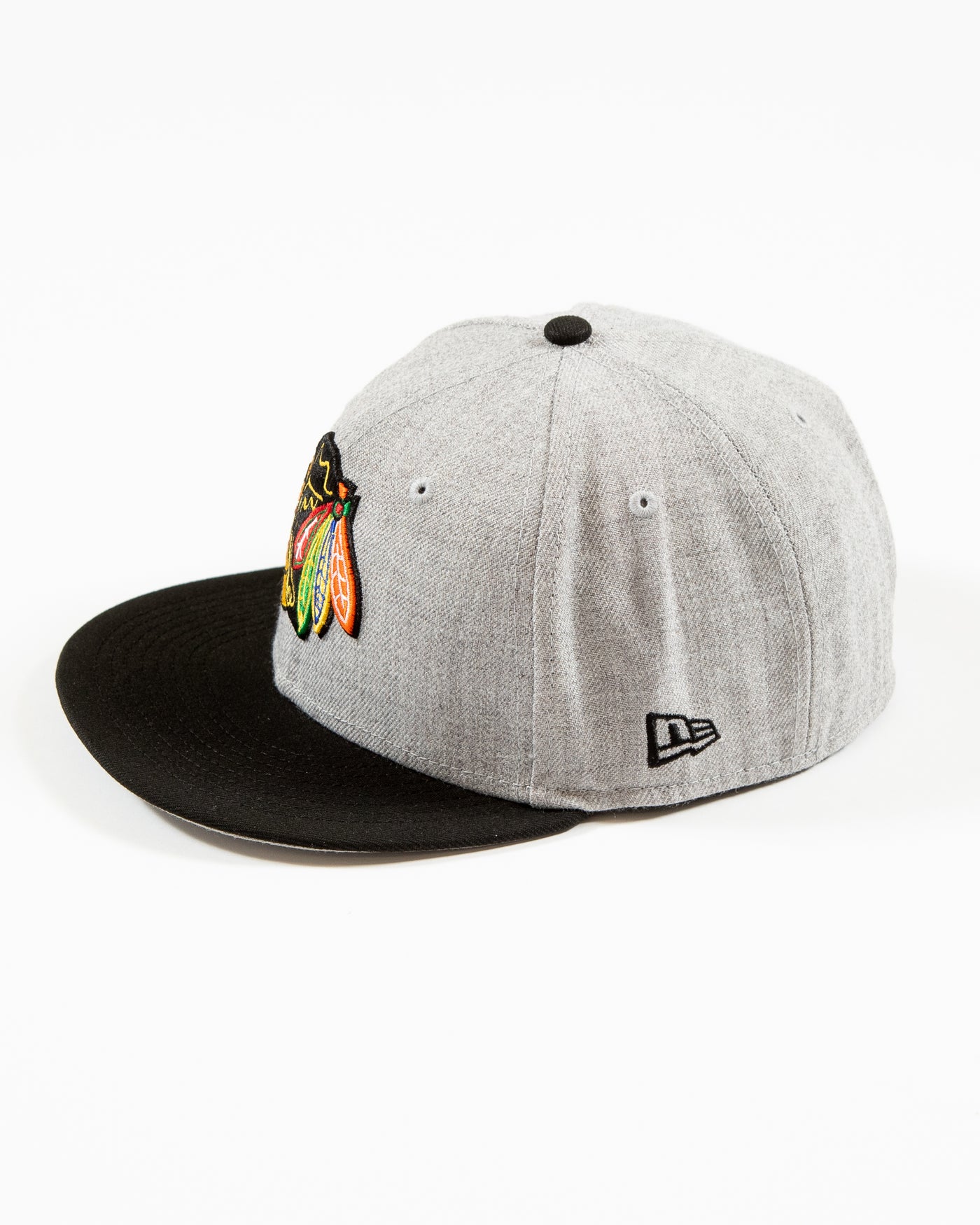 grey and black New Era 59FIFTY fitted cap with Chicago Blackhawks primary logo embroidered on front and patch adorning right side - left side lay flat