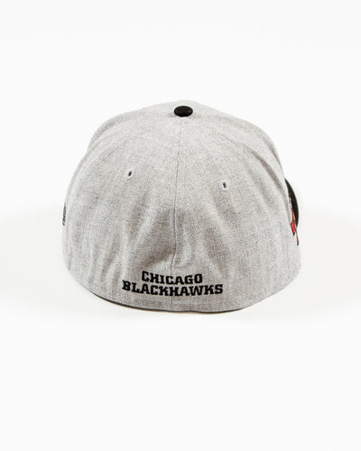 grey and black New Era 59FIFTY fitted cap with Chicago Blackhawks primary logo embroidered on front and patch adorning right side - back lay flat