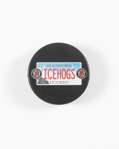 black hockey puck with Rockford IceHogs license plate inspired design - front lay flat