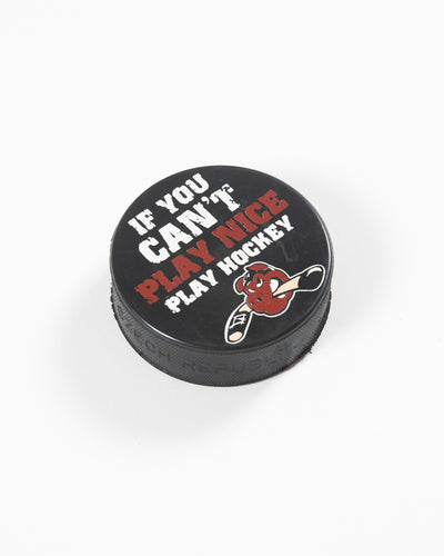 black hockey puck with Rockford IceHog Hammy and If You Can't Play Nice Play Hockey wordmark - angled lay flat