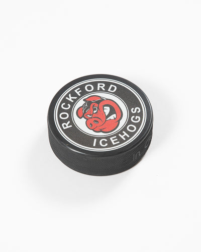black hockey puck with Rockford IceHogs logo on front - angled lay flat