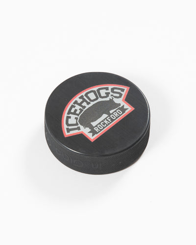 black hockey puck with Rockford IceHogs logo - angled lay flat
