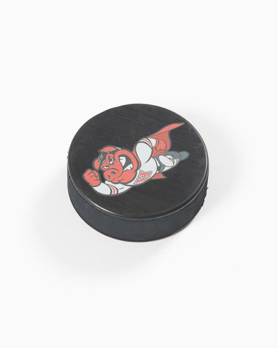 black hockey puck with Rockford IceHog Hammy in superhero outfit - angled lay flat