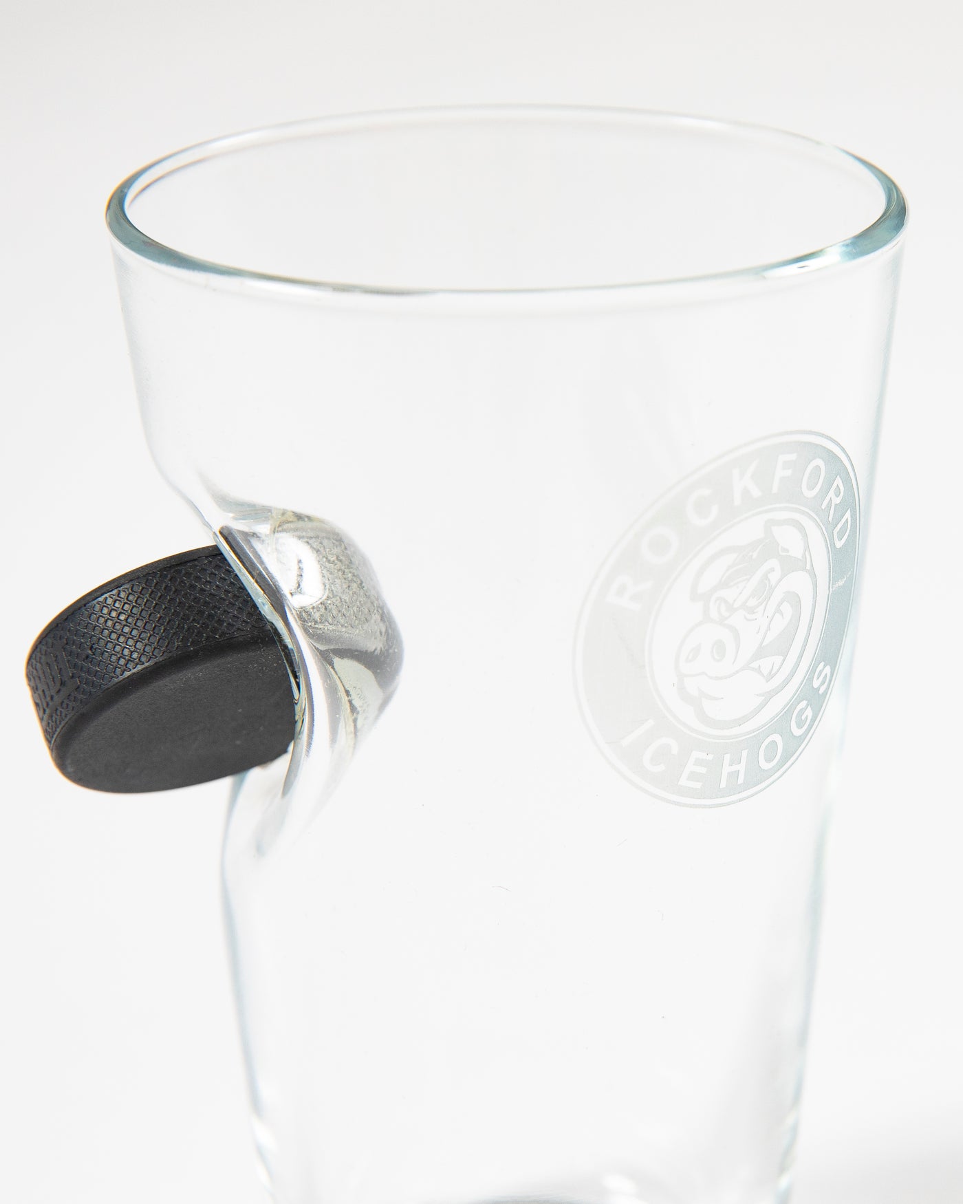 Rockford IceHogs pint glass with puck on side - detail lay flat