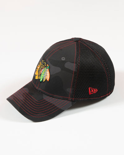 black camo New Era fitted cap with Chicago Blackhawks primary logo embroidered on front - left angle lay flat
