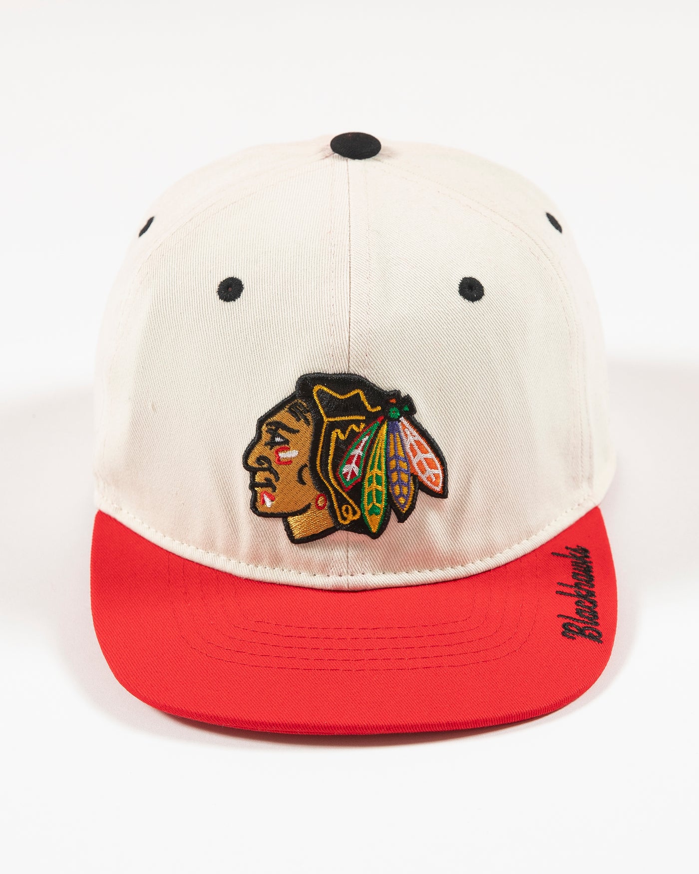 Outerstuff two-tone youth hat in bone and red with Chicago Blackhawks primary logo embroidered on front and Blackhawks script on left panel -front lay flat