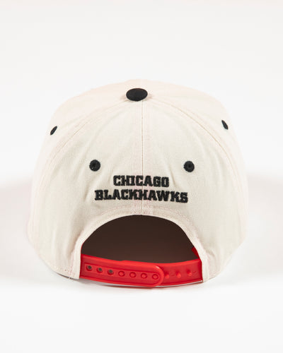 Outerstuff two-tone youth hat in bone and red with Chicago Blackhawks primary logo embroidered on front and Blackhawks script on left panel - back lay flat