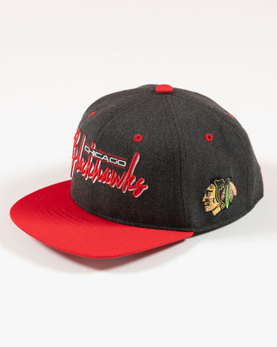 Outerstuff faded black and red Chicago Blackhawks wordmark youth cap - left angle lay flat