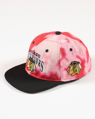 Outerstuff red bleached youth snapback with Chicago Blackhawks wordmark and primary logo embroidered on front - left angle lay flat