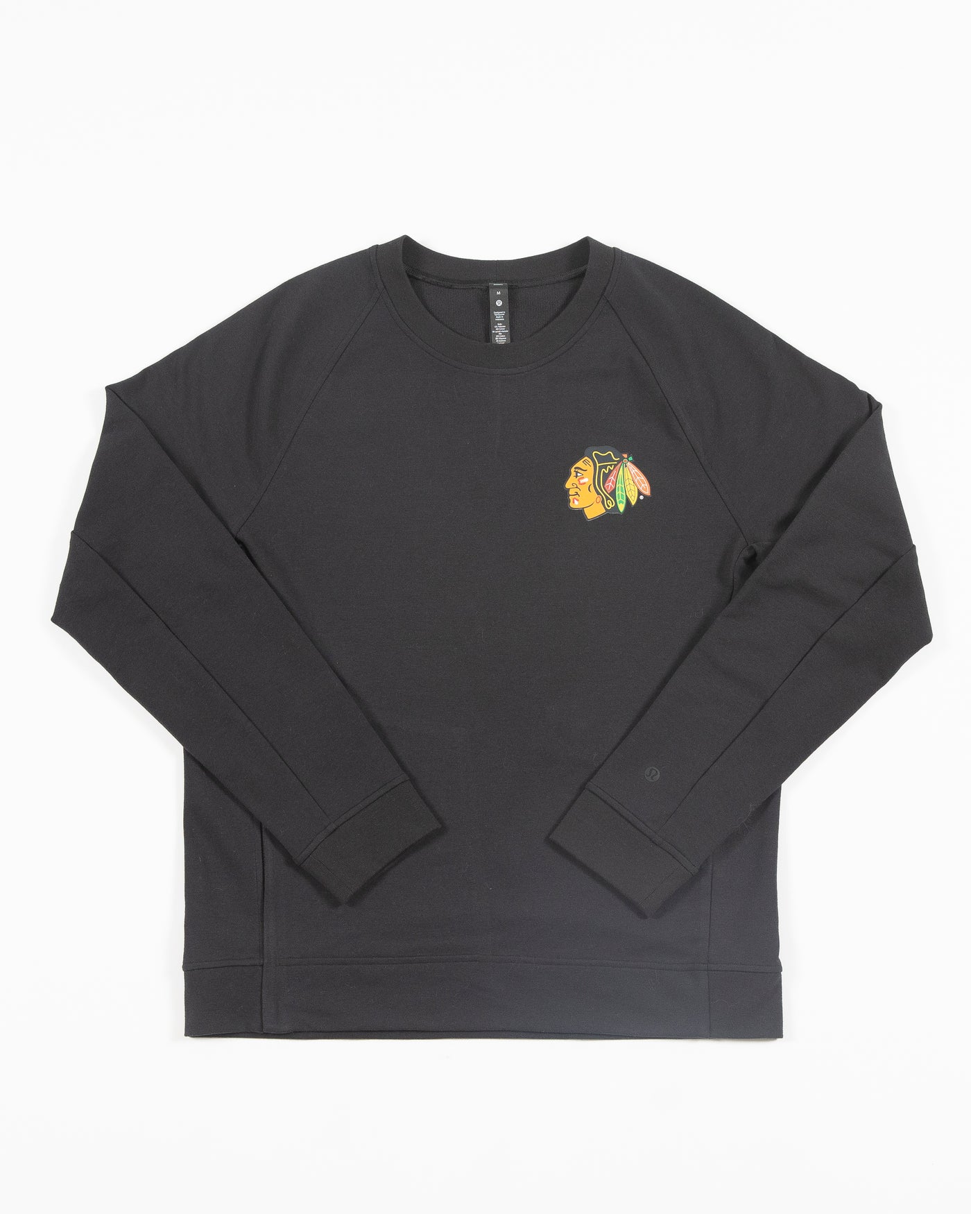 black lululemon crewneck sweater with Chicago Blackhawks primary logo on left chest - front lay flat