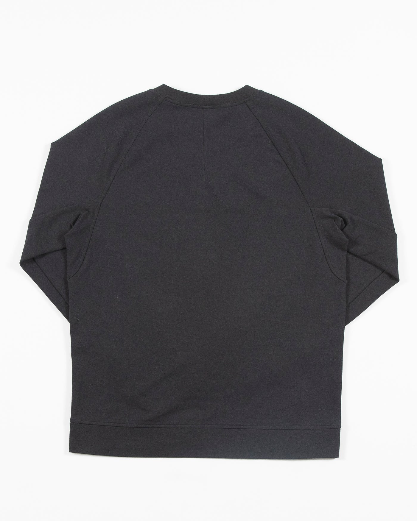 black lululemon crewneck sweater with Chicago Blackhawks primary logo on left chest - back lay flat