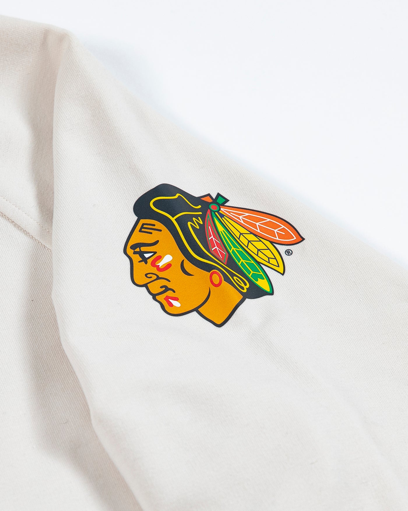 white lululemon crewneck sweater with Chicago Blackhawks primary logo on left shoulder - detail lay flat