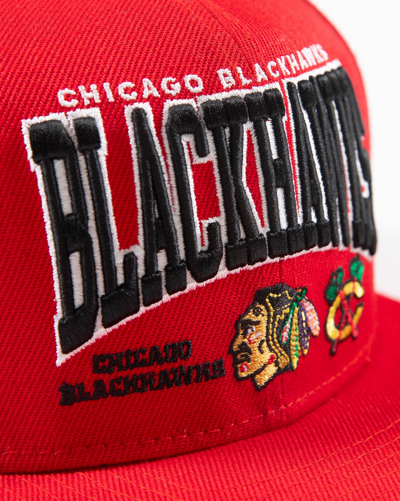 red Mitchell & Ness youth snapback with Chicago Blackhawks wordmark graphic and primary and secondary logos embroidered on front - detail 