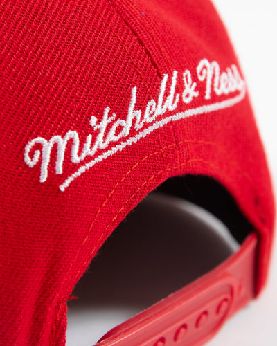 red Mitchell & Ness youth snapback with Chicago Blackhawks wordmark graphic and primary and secondary logos embroidered on front - detail lay flat