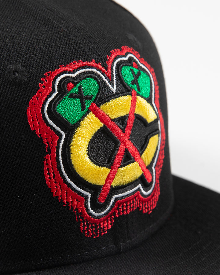 black Mitchell & Ness snapback with Chicago Blackhawks secondary logo embroidered on front and primary logo patch embroidered on right side - detail front lay flat 