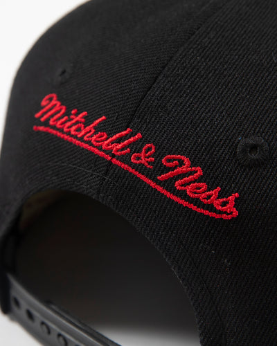 black youth Mitchell & Ness snapback cap with Chicago Blackhawks secondary tomahawk logo embroidered on front and 75th anniversary patch embroidered on right side - detail lay flat
