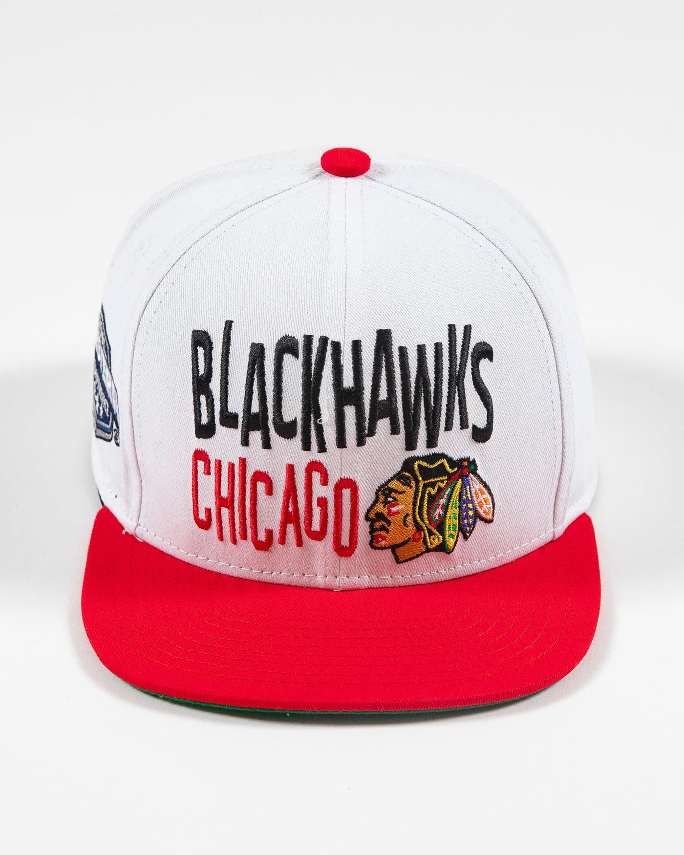 white and red Mitchell & Ness youth snapback with Chicago Blackhawks wordmark and primary logo embroidered on front - front lay flat