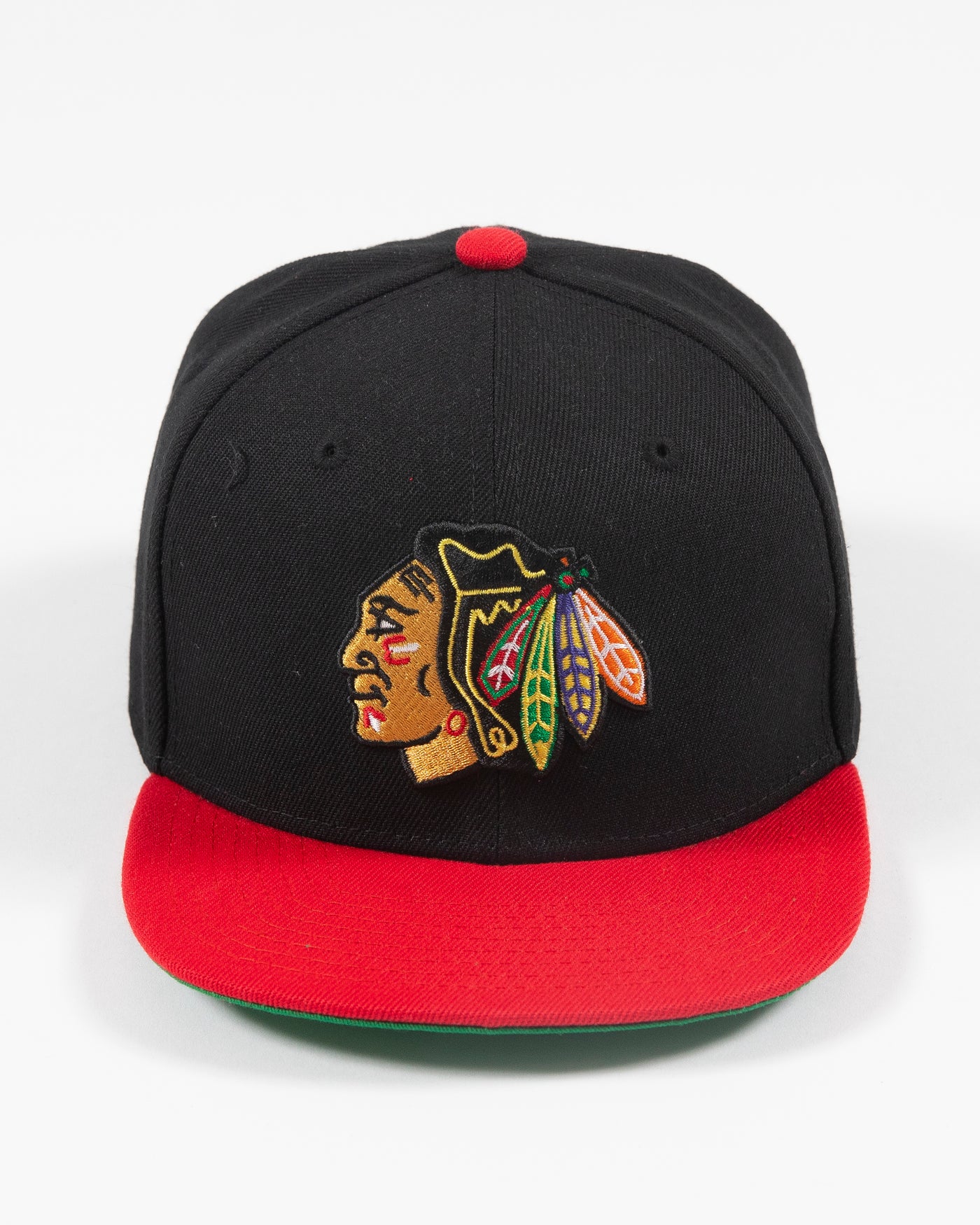 black and red Mitchell & Ness youth snapback with Chicago Blackhawks primary logo embroidered on front - front lay flat