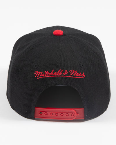 black and red Mitchell & Ness youth snapback with Chicago Blackhawks primary logo embroidered on front - back lay flat