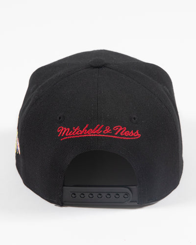black and red Mitchell & Ness youth snapback cap with Chicago Blackhawks wordmark embroidered on front and primary logo embroidered on left side - back lay flat