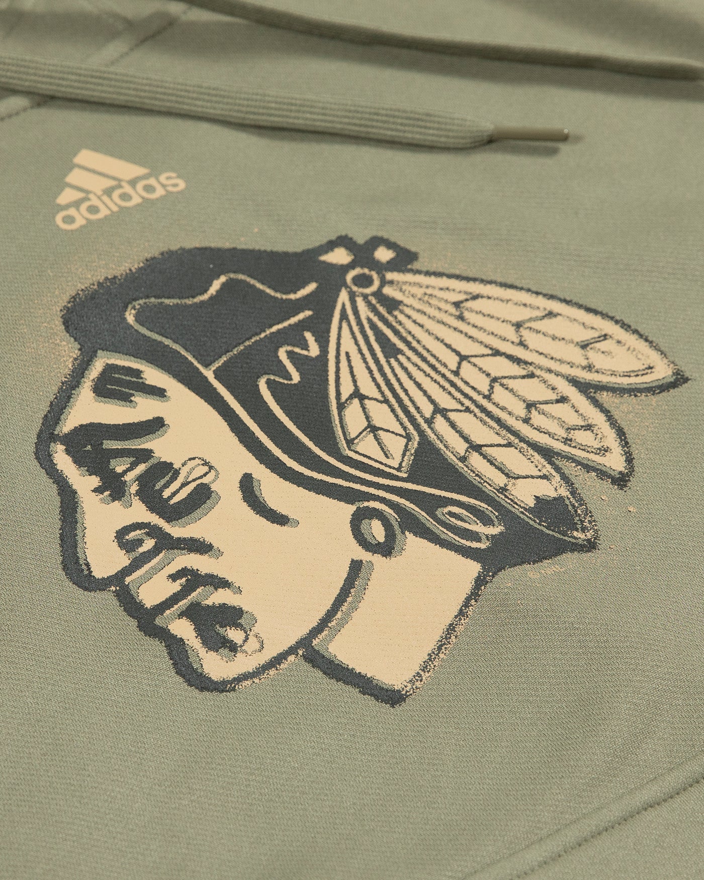 green adidas military salute hoodie with Chicago Blackhawks primary logo across chest - detail lay flat