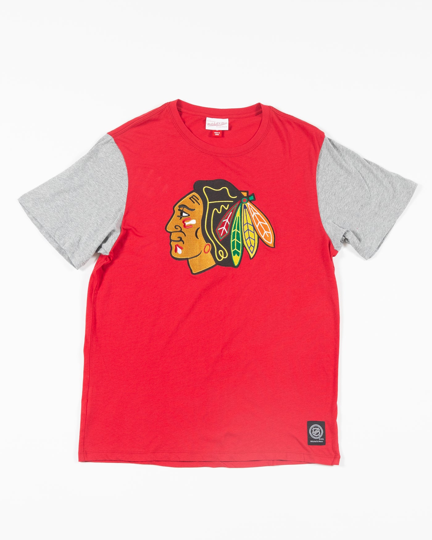 Mitchell & Ness red t-shirt with grey color blocked sleeves with Chicago Blackhawks primary logo across front chest - front lay flat