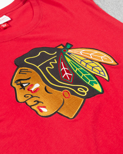 Mitchell & Ness red t-shirt with grey color blocked sleeves with Chicago Blackhawks primary logo across front chest - detail lay flat
