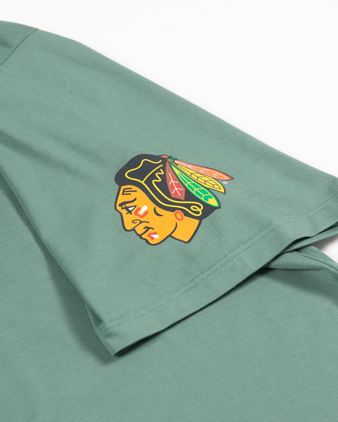 green lululemon t-shirt with Chicago Blackhawks primary logo on left shoulder - detail lay flat