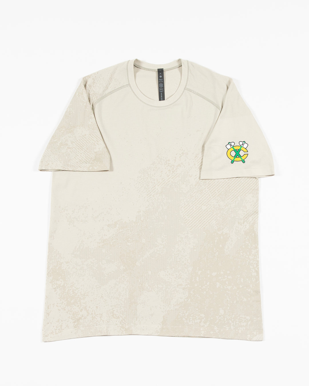 off white lululemon short sleeve t-shirt with Chicago Blackhawks secondary logo on left shoulder - front lay flat