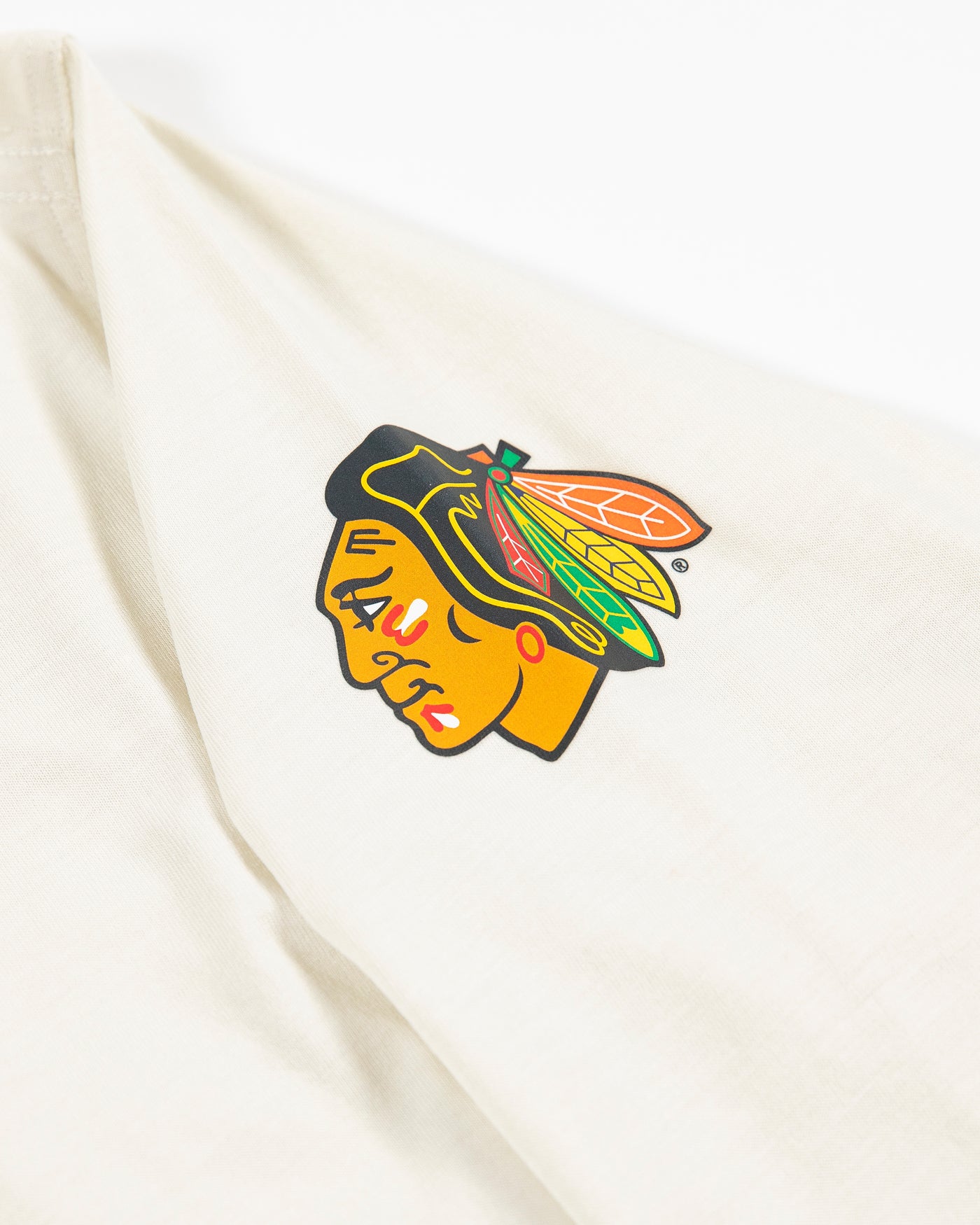 white lululemon long sleeve women's shirt with Chicago Blackhawks primary logo on left shoulder - detail lay flat