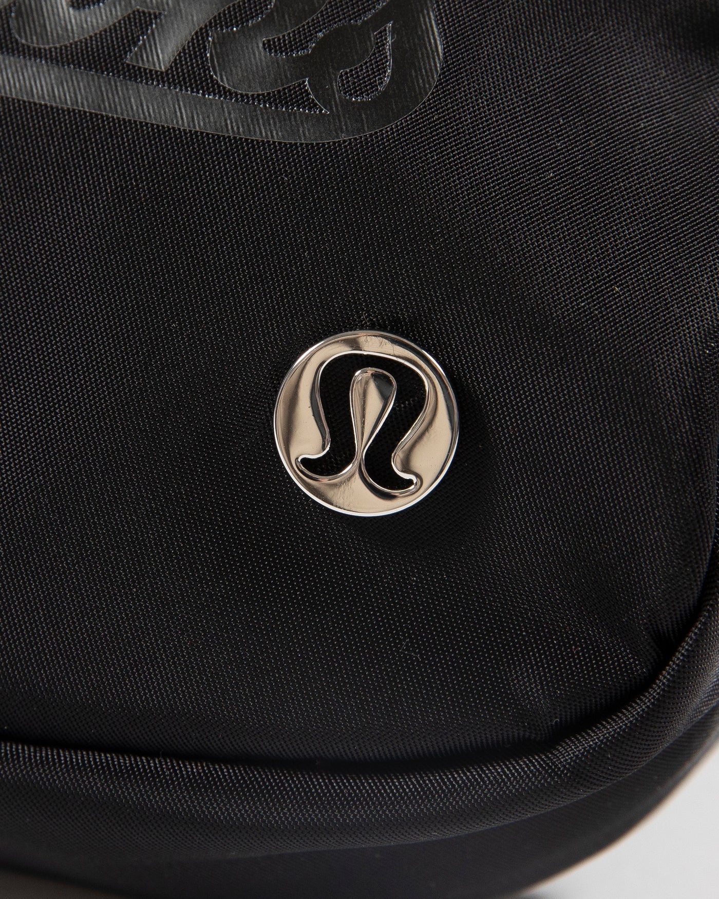 black lululemon Everywhere Belt Bag with Chicago Blackhawks wordmark graphic in black across front - detail lay flat