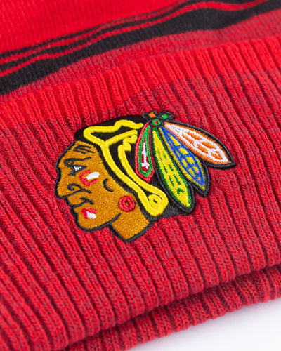 red and black '47 brand knit beanie with red pom and Chicago Blackhawks primary logo embroidered on front cuff - detail lay flat