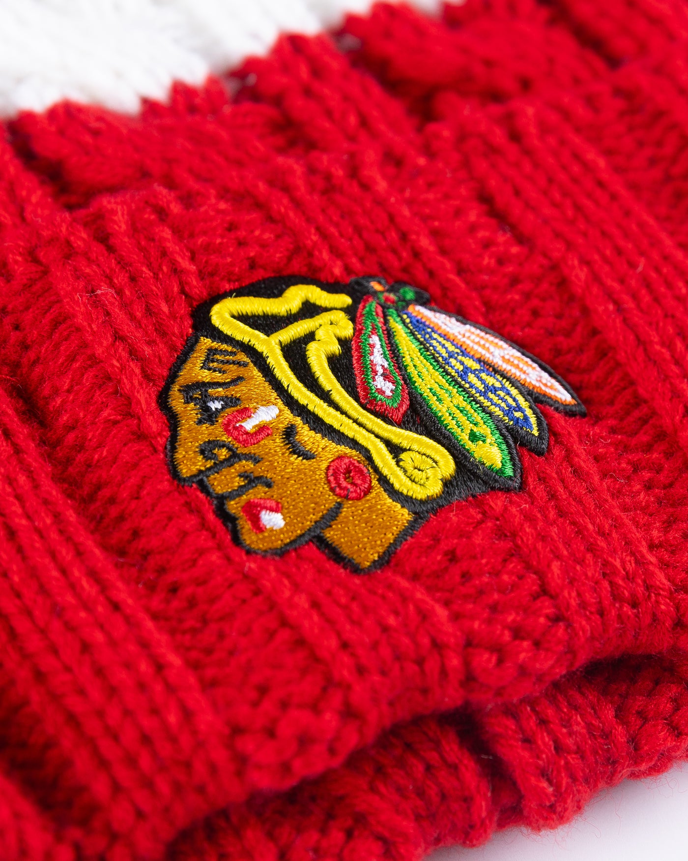 women's '47 brand red, white and black knit beanie with multi color pom and Chicago Blackhawks primary logo embroidered on front cuff - detail lay flat