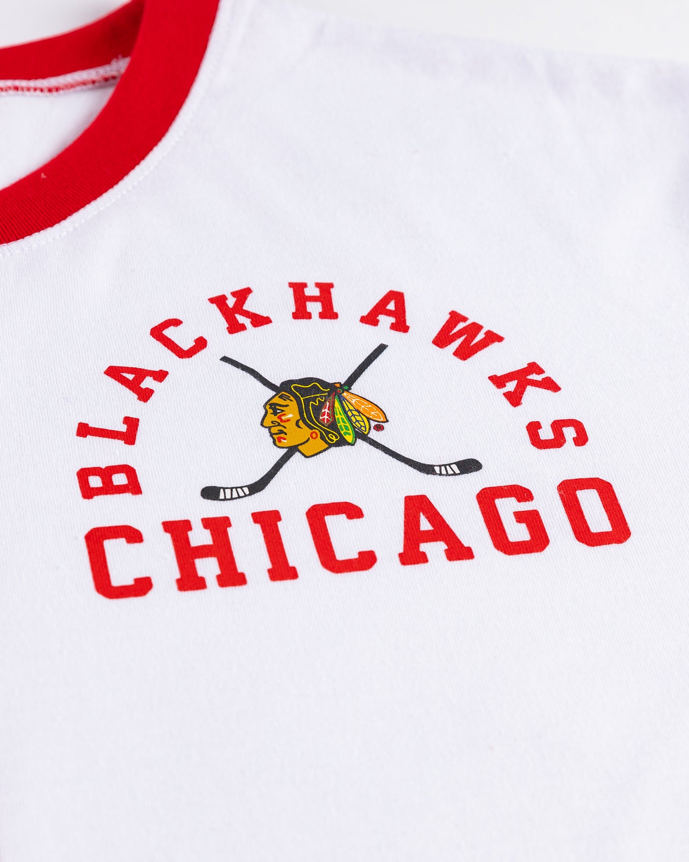 red and white Zoozats colorblock ladies cropped tee with Chicago Blackhawks graphic on left chest - detail lay flat 