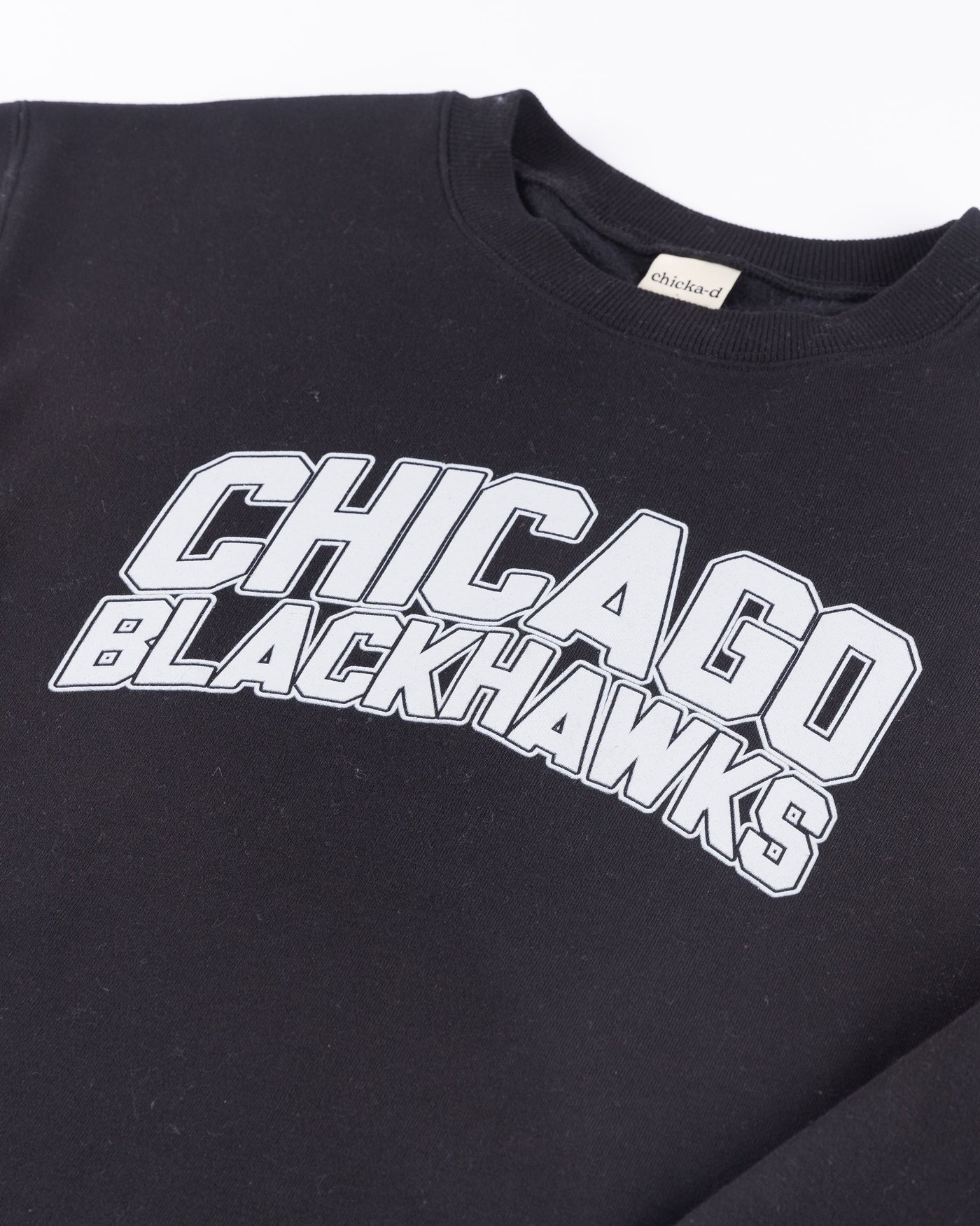 black chicka-d crewneck with Chicago Blackhawks wordmark across front - detail lay flat