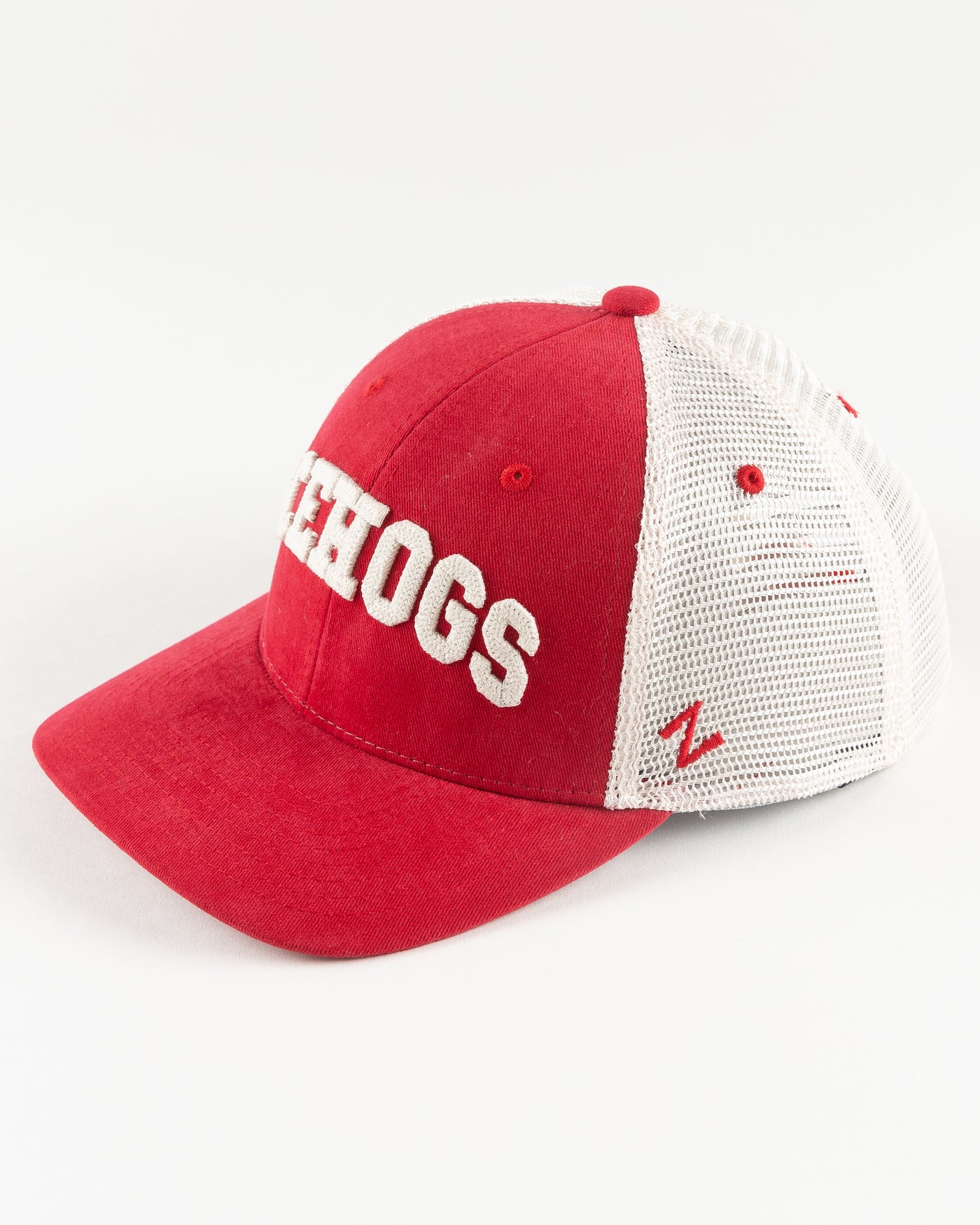 red and white Rockford IceHogs trucker with embroidered wordmark on front- left angle lay flat