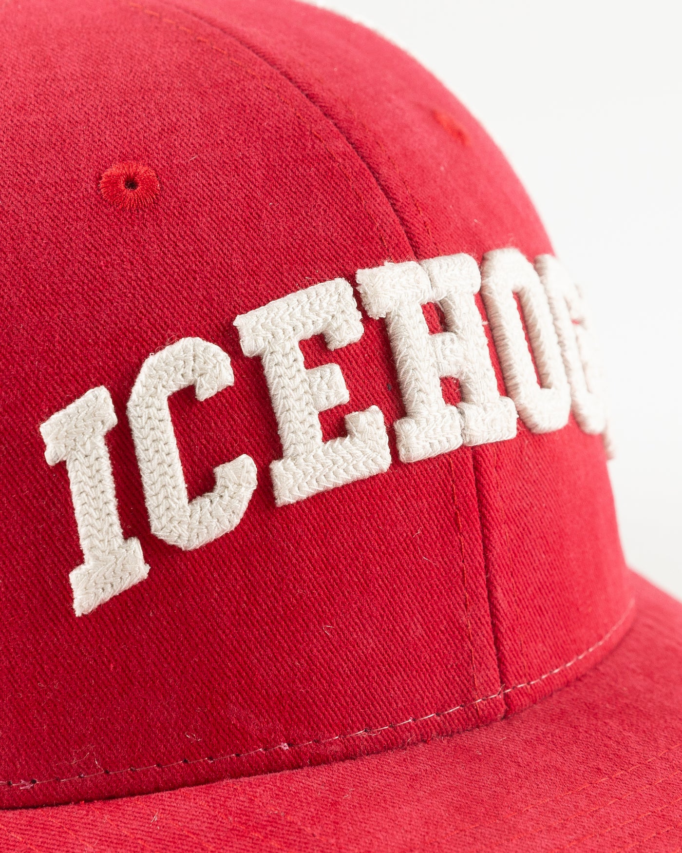 red and white Rockford IceHogs trucker with embroidered wordmark on front- detail lay flat