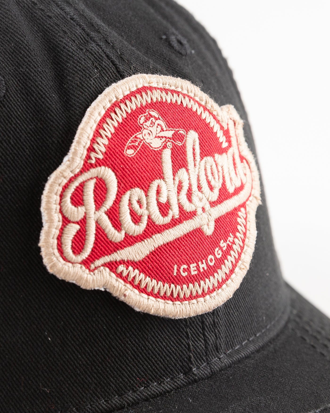 black Rockford IceHogs cap with embroidered red patch on front - detail lay flat