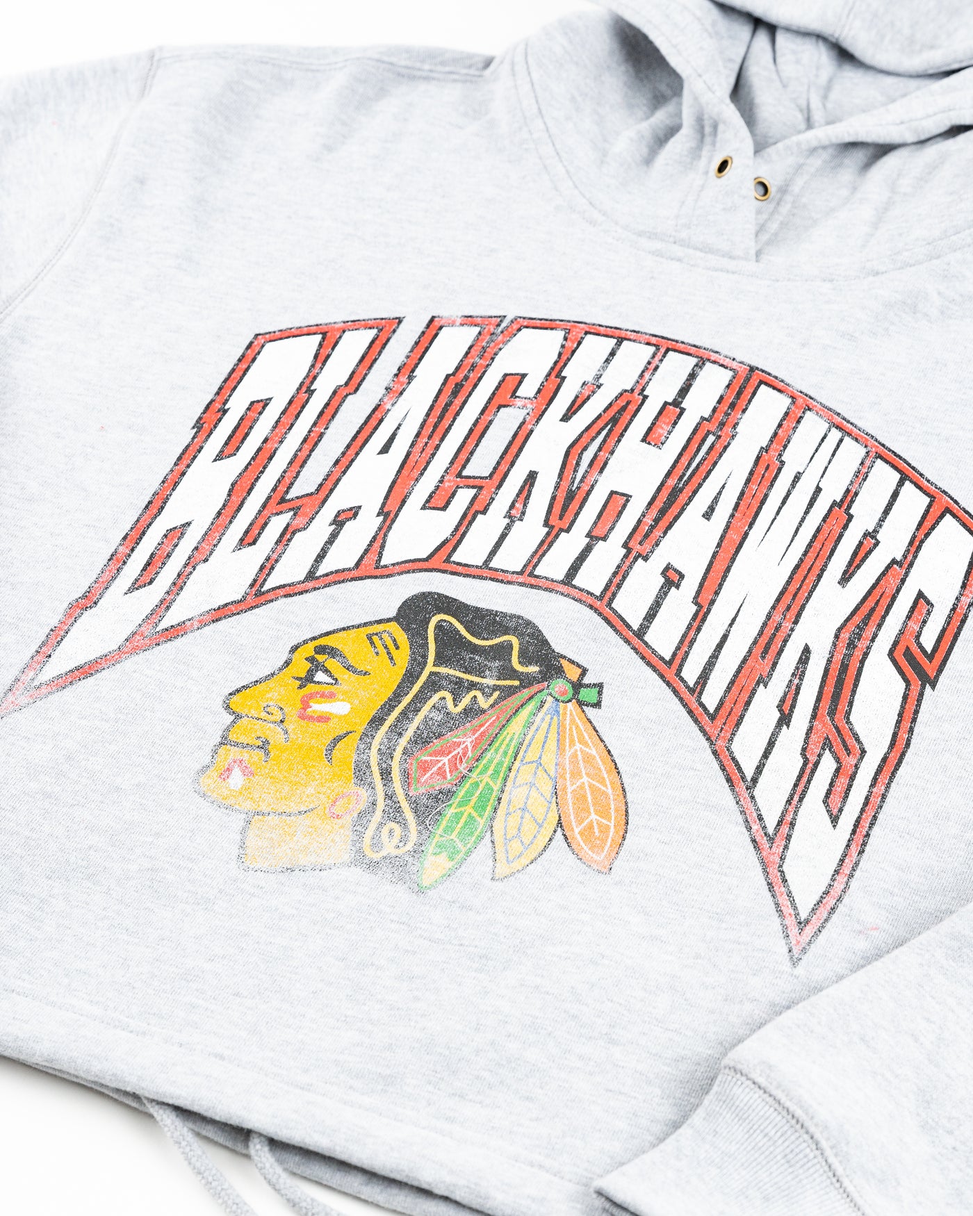 grey '47 brand cropped women's hoodie with Chicago Blackhawks distressed graphic on front - detail lay flat
