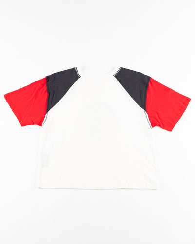 white 47 brand ladies tee with colorblocked black and red sleeves with Chicago Blackhawks primary logo across front - back lay flat