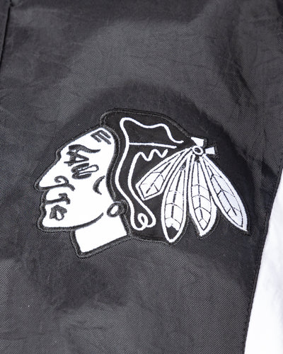 black Starter windbreaker jacket with Chicago Blackhawks wordmark and primary logo - detail front lay flat