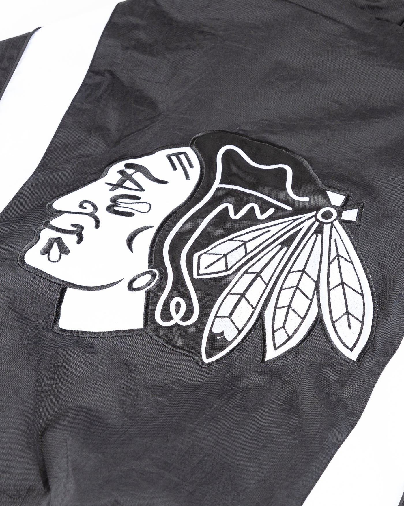 black Starter windbreaker jacket with Chicago Blackhawks wordmark and primary logo - detail back lay flat