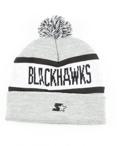 grey black and white knit beanie with Chicago Blackhawks primary logo embroidered on front and wordmark across - back lay flat