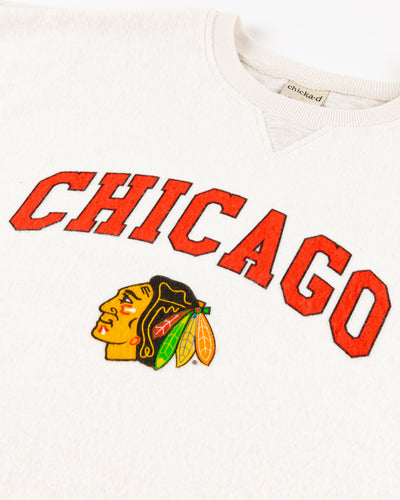 white chicka-d ladies crewneck with Chicago wordmark and Chicago Blackhawks primary logo - detail lay flat