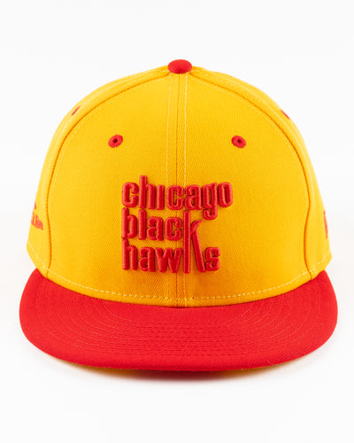 yellow and red New Era fitted cap with Chicago Blackhawks wordmark on front - front lay flat