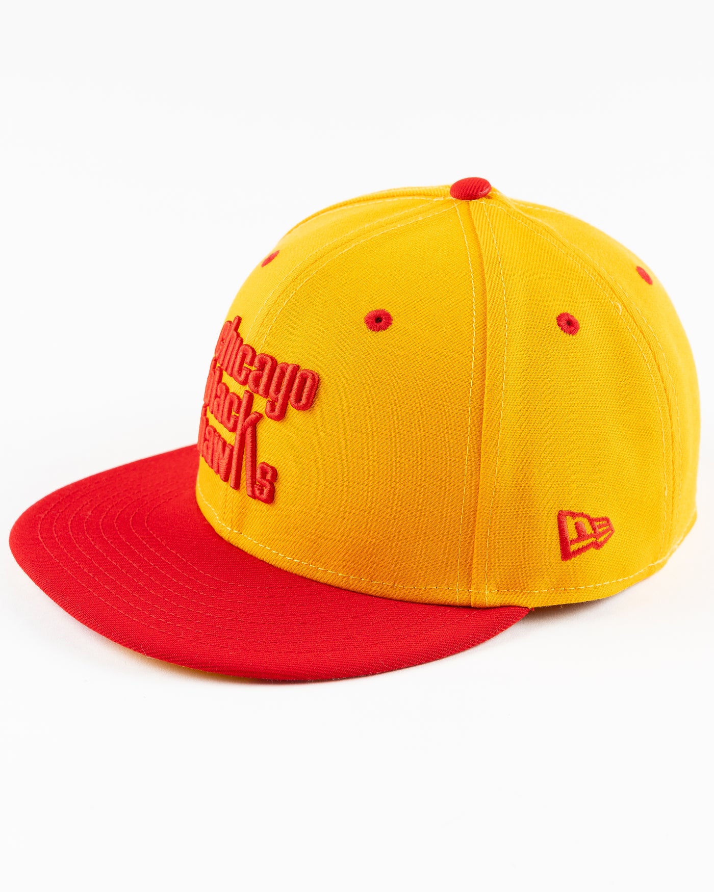 yellow and red New Era fitted cap with Chicago Blackhawks wordmark on front - left angle lay flat