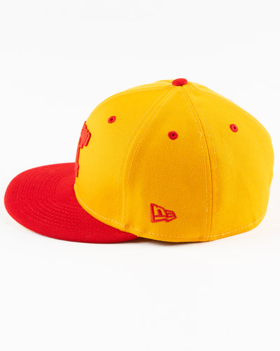 yellow and red New Era fitted cap with Chicago Blackhawks wordmark on front - left side lay flat