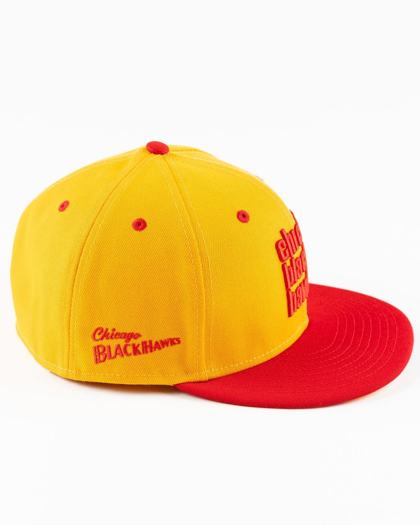 yellow and red New Era fitted cap with Chicago Blackhawks wordmark on front - right side lay flat